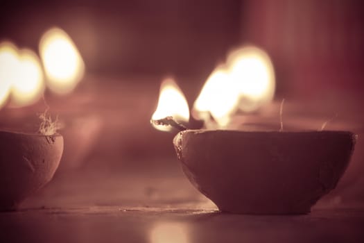 multiple oil lamps lit on diwali festival