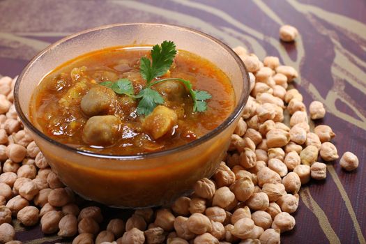 spicy chana masala, raw chickpeas around the bowl
indian dish