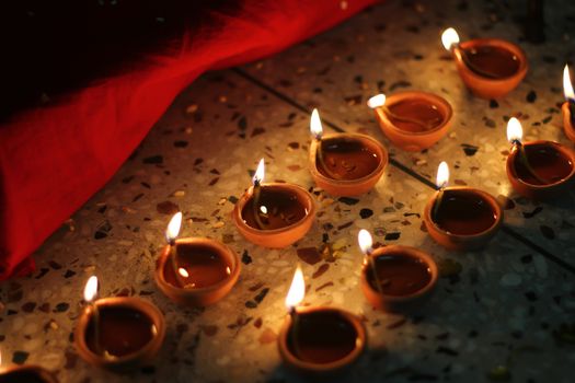 series of oil lamps lit on deepawali festival in india