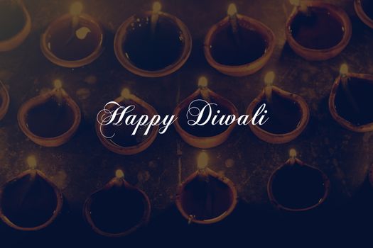 happy diwali text with oil lamps, festival celebration, retro effect