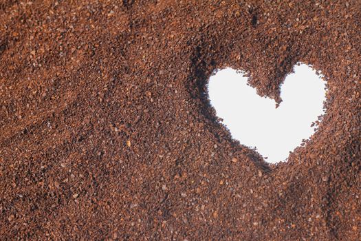 figure drawings in the shape of a heart on the cocoa powder scattered on a white background