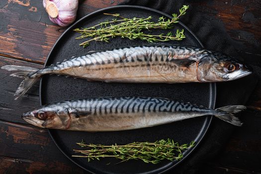 Mackerel with ingredients on wooden table, top view.