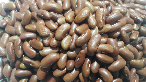 Kidenry beans:   Closeup view of uncooked red kidney beans. Dark red useful beans background.