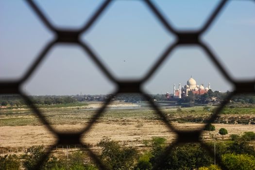 View of Taj Mahal from lattice jali in Agra, Uttar Pradesh, India. It was build in 1632 by Emperor Shah Jahan as a memorial for his second wife Mumtaz Mahal