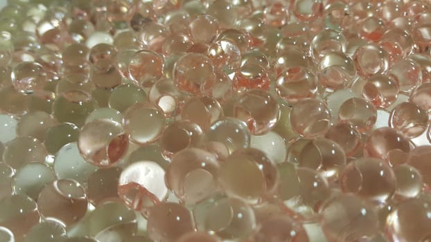 Closeup view with selective focus of shiny glittering orbeez or colorful water balls hydrogel. Water beads orbeez background.