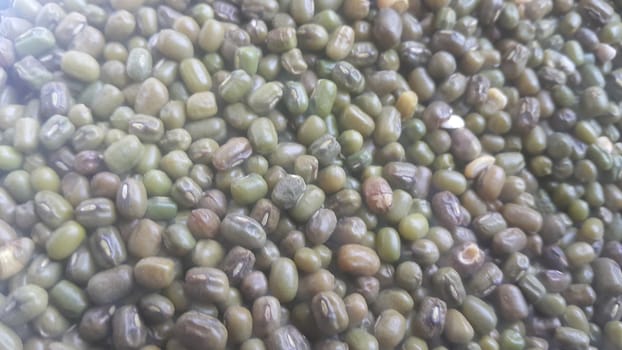 Closeup view of green whole Mung bean or green gram, maash, or moong. It is used as an ingredient in both savory and sweet dishes.