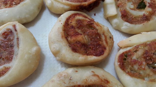 Closeup of delicious home made pinwheel puff pastries food item placed over white background
