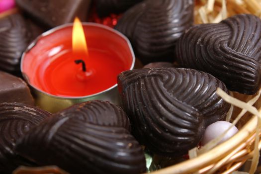 candle at center of home made chocolates - retro style
