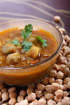 spicy chana masala, raw chickpeas around the bowl
indian dish
