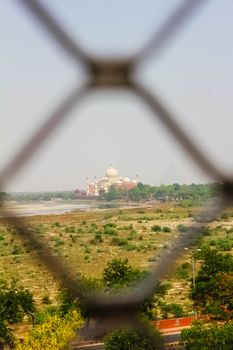 Taj Mahal, Agra, India. Picture taken in fort from a far distance through jali, Uttar Pradesh