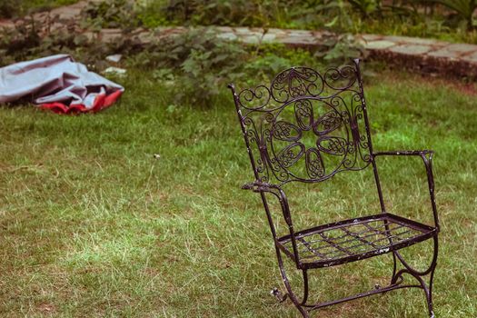 hand crafted wrought iron bench in a lush green park 