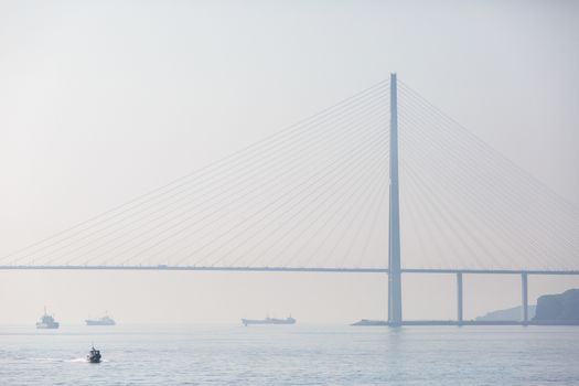 Russian bridge in Vladivostok is shrouded in thick fog.