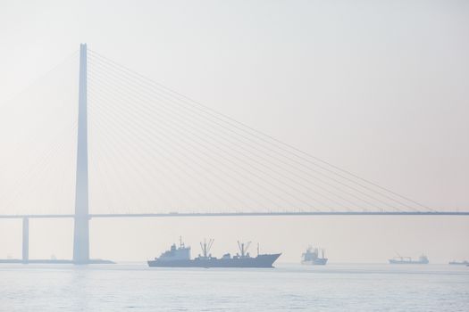 Russian bridge in Vladivostok is shrouded in thick fog.