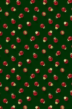 Christmas red decorations on green background. Christmas ornaments composition for background. Flat lay background madefrome red ornaments decorations