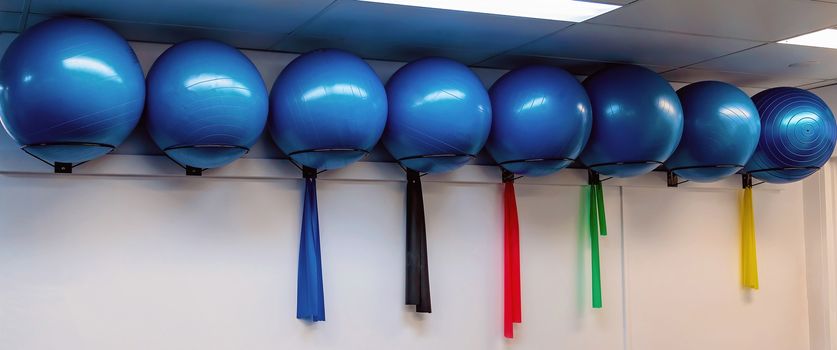 Large round blue pilates exercise balls in a row in a physiotherapist clinic