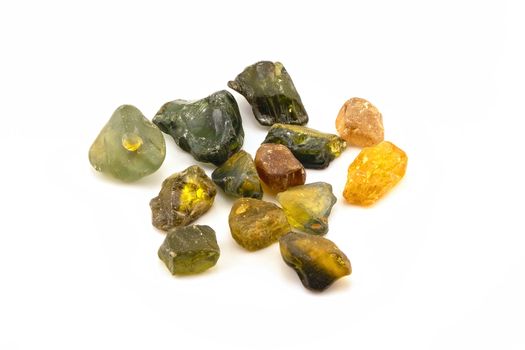 A collection of uncut natural sapphires isolated on a white background