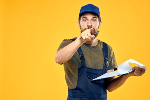 Man in working form documents transportation delivery service yellow background. High quality photo