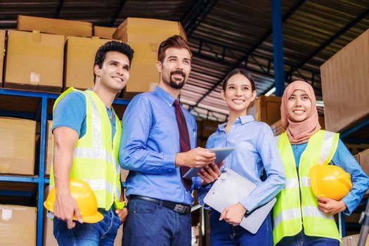 Group of Diversity warehouse worker standing and Proud of the team for vision and target of manager in local warehouse, muslim, indian, white caucasian and asian people in export industry concept