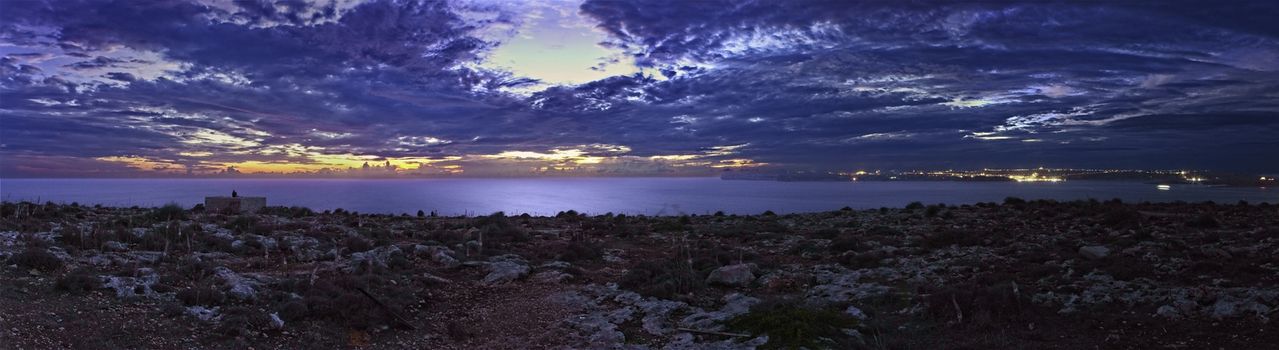 A panoramic shot of a beautiful sunset over Gozo