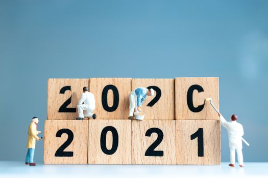 Miniature worker team painted number 2021 and remove number 2020 , Happy new year concept