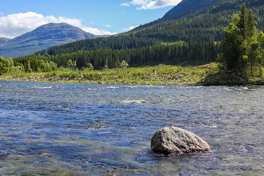 Flowing beautiful river lake Hemsila with mountain panorama in Hemsedal, Viken, Buskerud, Norway.