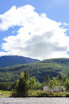 Flowing beautiful river lake Hemsila with mountain panorama in Hemsedal, Viken, Buskerud, Norway.