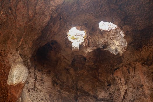 High angle view of rock formation. Fallen cave ceiling. A hole in the ceiling of the cave.