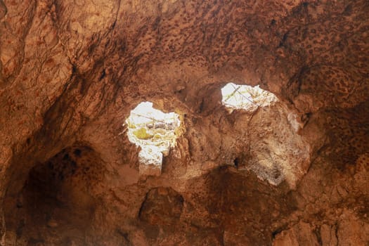 High angle view of rock formation. Fallen cave ceiling. A hole in the ceiling of the cave.