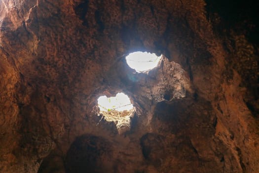 High angle view of rock formation. Fallen cave ceiling. A hole in the ceiling of the cave.