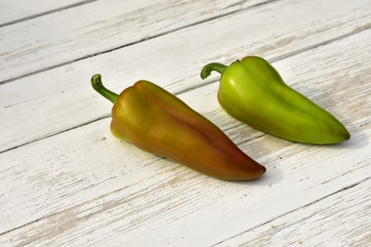 two pods of bell pepper on a wooden vintage table