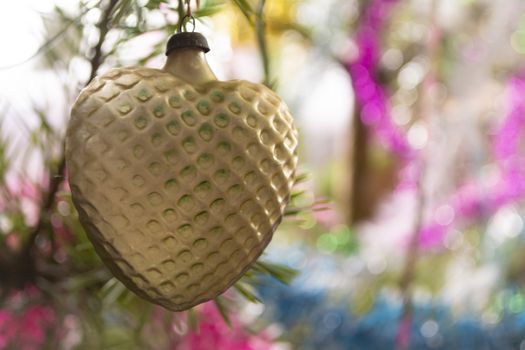 Vintage yellow glass decoration heart on the Christmas tree, retro toy from 70th URSS
