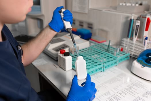 laboratory assistant analyzing a blood sample using micropipette.