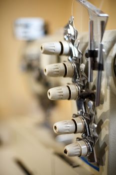 closeup details on sewing machine overlock. Workplace seamstress.Tailoring industry.