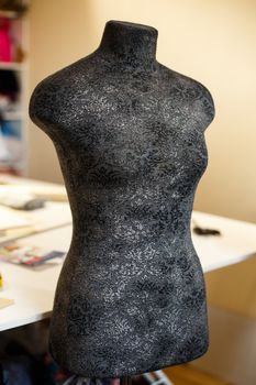 Black color mannequin for fitting and tailoring in workshop. Tailor industry.