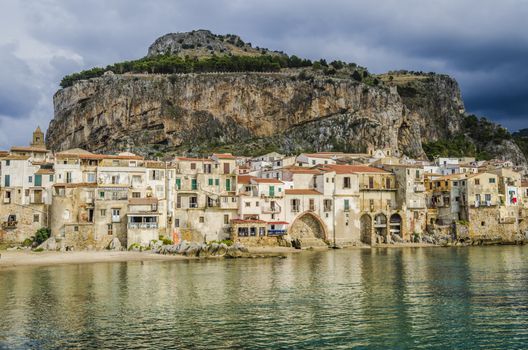Beach of cefalu with its old constructions and in the background a great formation known as the rock on the same are the ruins of the ancient temple of diana