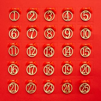 Abstract red Christmas advent calendar background with perforation windows in paper and day numbers and ribbon bows