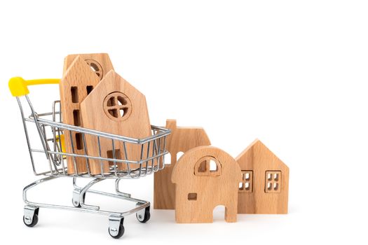 Wooden house model in the shopping cart on white background for housing and property concept