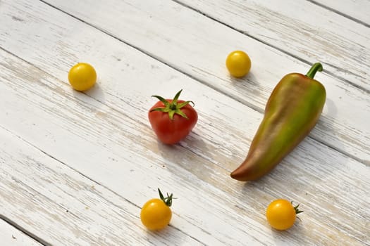 red tomato four yellow small tomatoes bell pepper pod