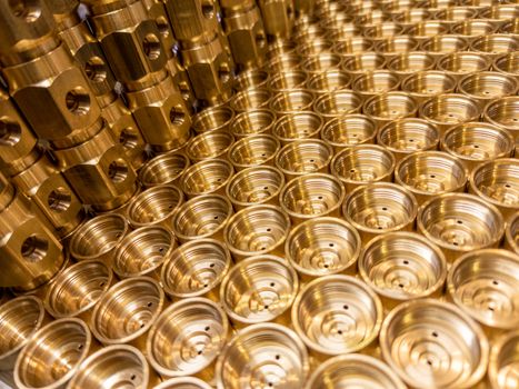 shiny brass metal threaded hexagonal fitting parts, abstract perspective industrial close-up background.