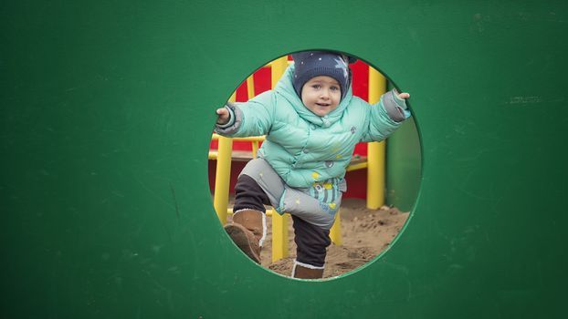 Happy child run and playing in the playground. cheerful child on the playground