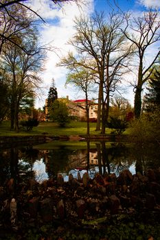 Looking Out Over a Lake at a Large Detailed Estate Reflecting Off the Water's Surface