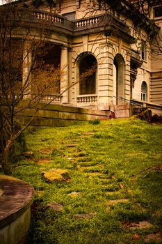 Stepping Stones Leading Up to an Arched Entrance to an Ornamental Stone Mansion