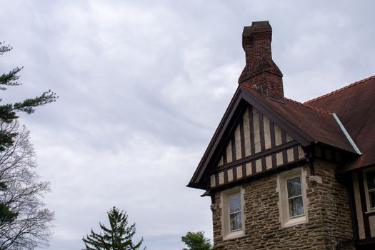 A Detailed and Ornamental Cobblestone Building With a Red Roof