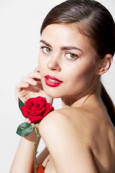 Woman with long hair Red lips luxury flowers bright makeup close-up