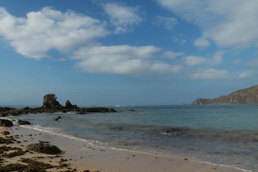 Rock formations on the beach Mandalika Kuta beach, Lombok, Indonesia. Blue sky and suuny day.