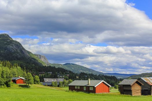 Panorama Norway, Hemsedal Mountains, red farmhouses and green meadows, Viken, Buskerud.