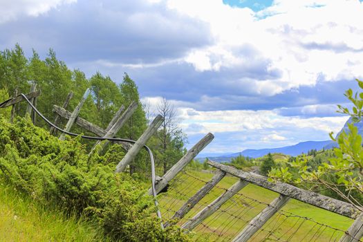 Stunning Norwegian landscape with mountains and valley behind a broken fence in Hemsedal, Norway.