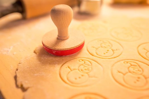 Christmas cookies bakery with raw biscuit dough and cutters with christmas theme shape