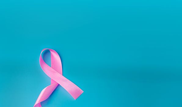 Pink ribbon On a blue background Conveys the awareness of cancer. World cancer day concept.