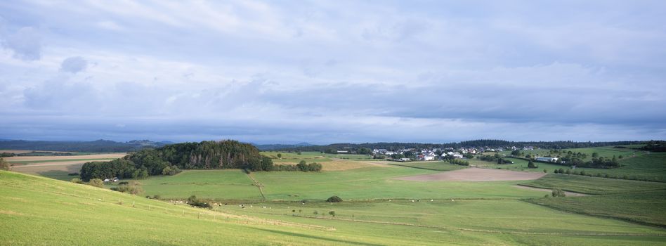 village in rural landscape of german vulkaneifel in summer